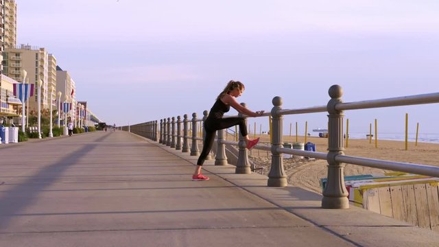 Person doing light stretching near waterfront